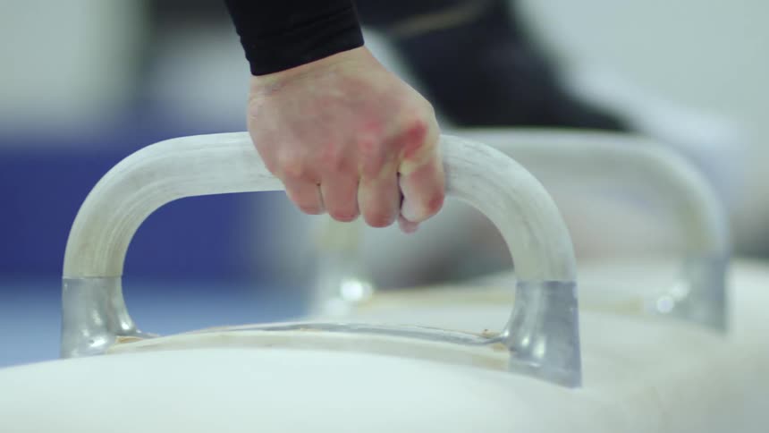 A gymnast on a saw horse