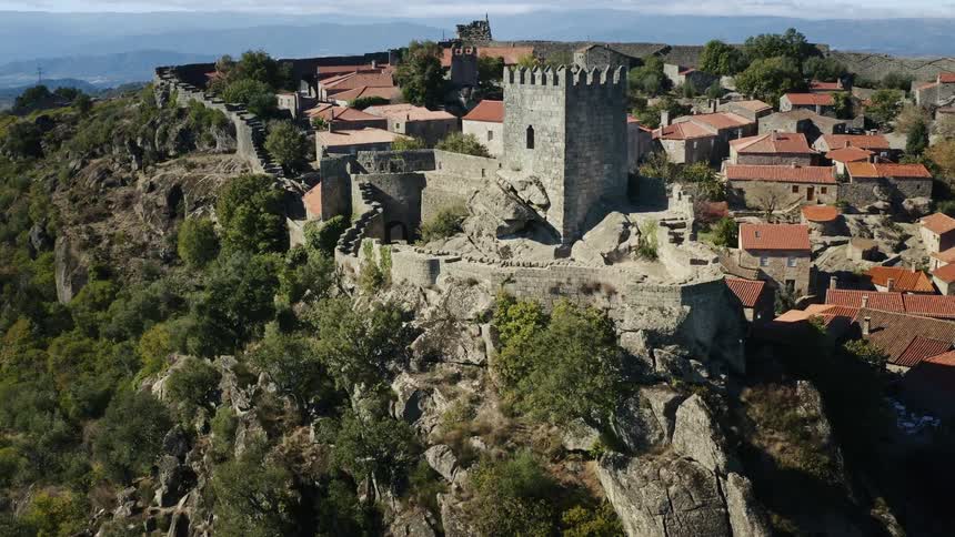 An aerial view of an old stone building in a town