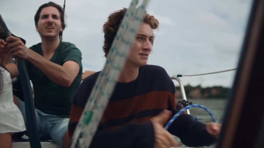 People are steering a sailboat