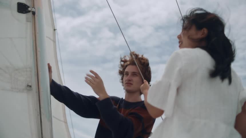 A man and woman talk while sailing