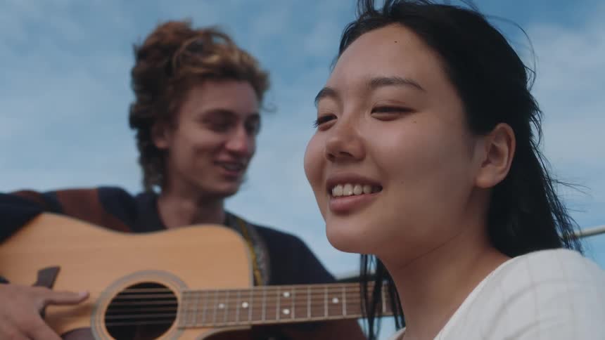 A man is playing guitar and singing