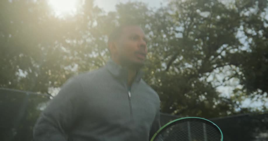 A man is playing a game of tennis outdoors