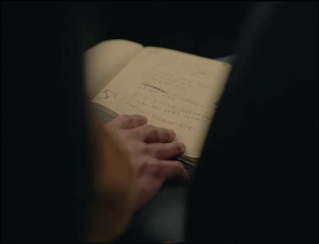 A man reading an open notebook