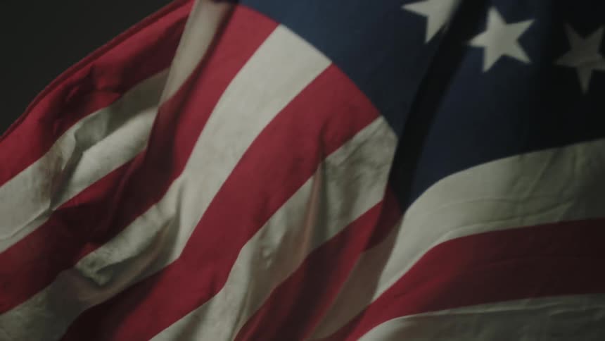 An old american flag waves around