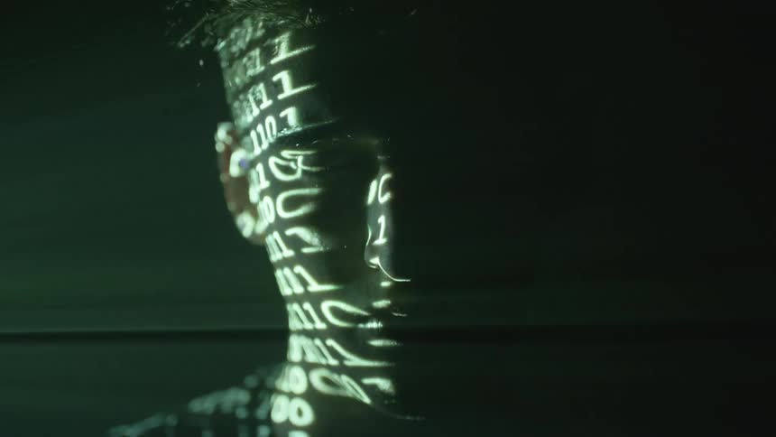 Ones or zeroes flash on a person's face