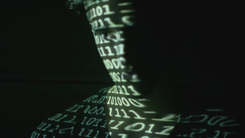 Projection of numbers covers a man in the dark