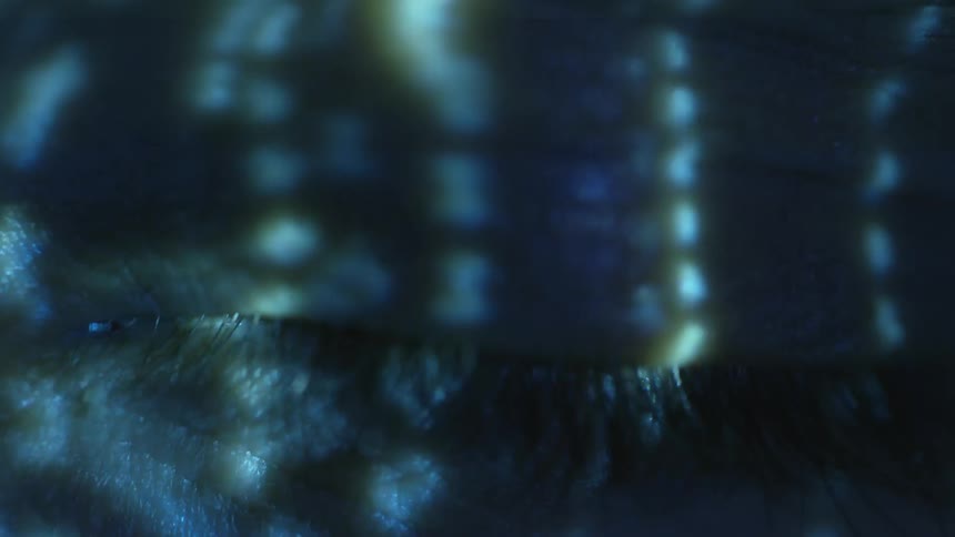 Lights flash on a person as they open their eye