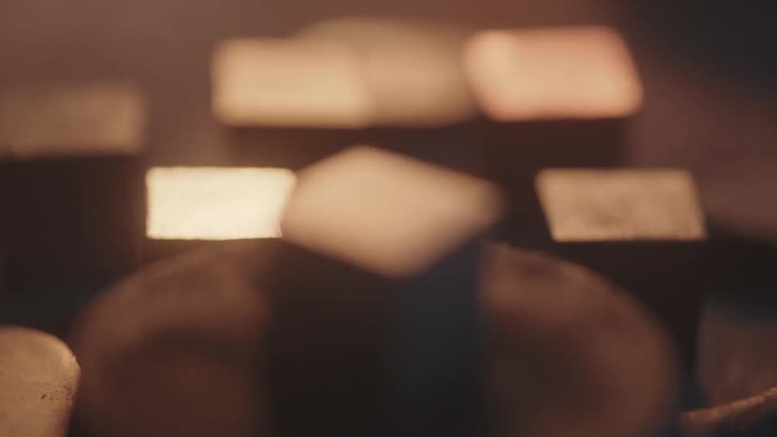 Light from a fire flickers on wooden cubes