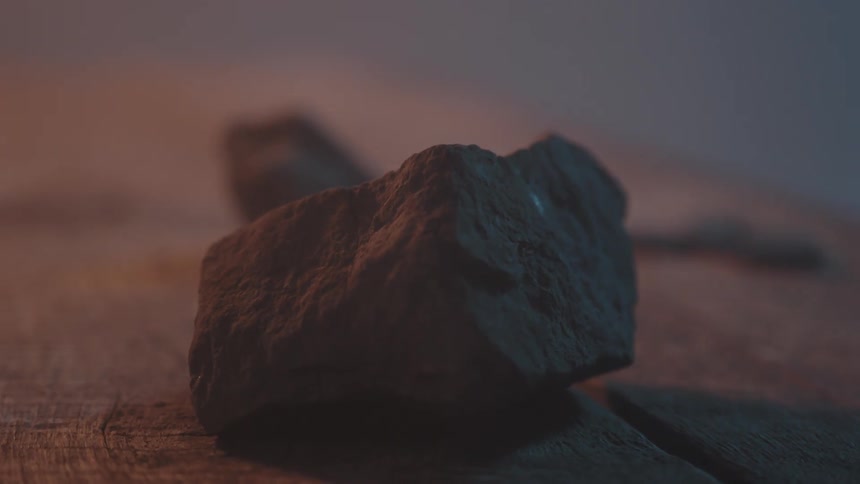 A couple of rocks sit on this table