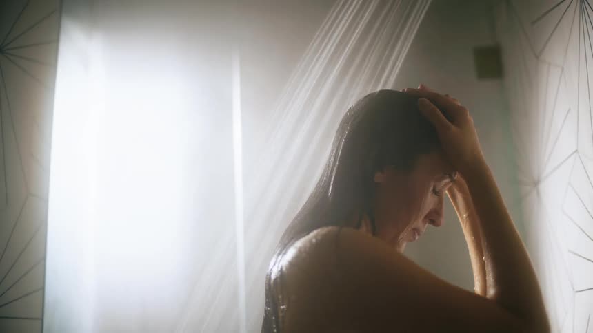 Close up of the head of a woman taking a steamy shower at home