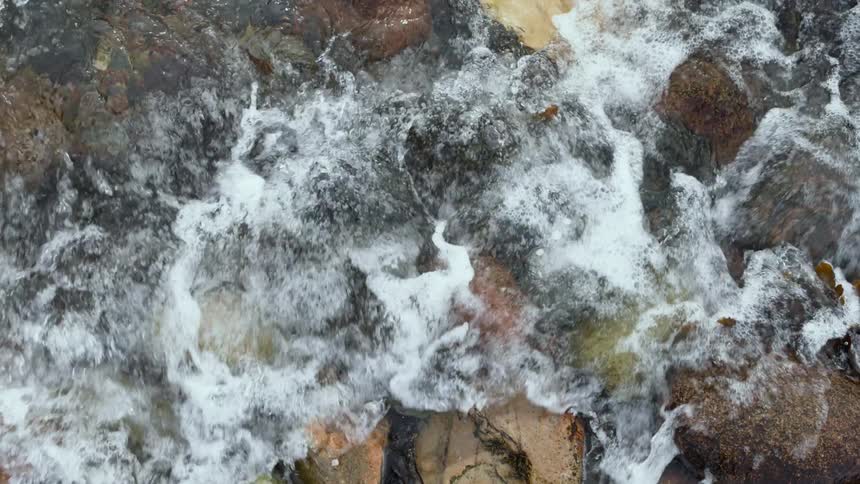 Close up of waves washing over the rocks in the coast