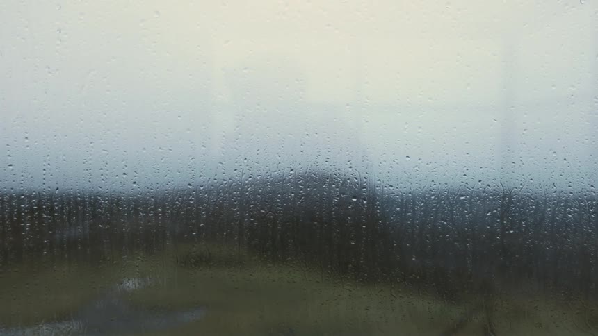 Foggy wet glass in the window obscures the view at evening