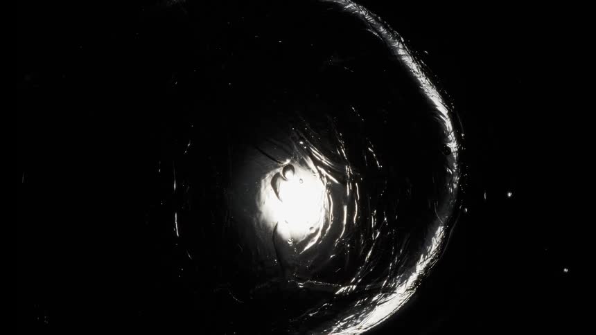 thick black liquid bubbling up reflecting light