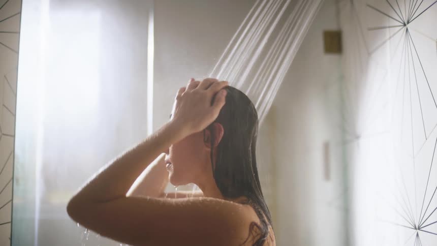 A woman is taking a shower