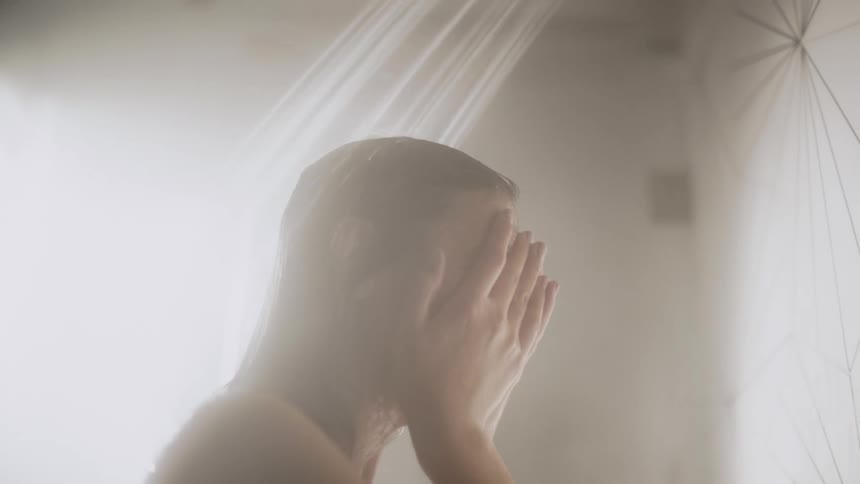 Close up of the head of a woman taking a steamy shower at home