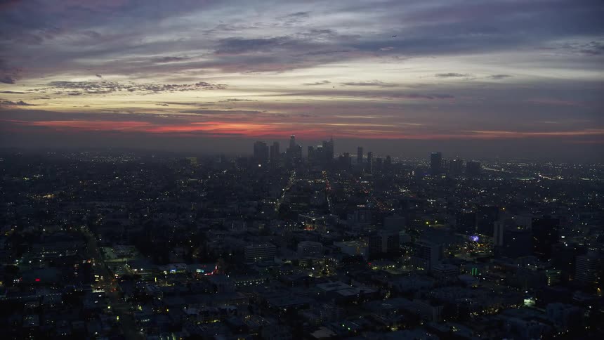 A breathtaking aerial footage of the sunrise over Downtown Los Angeles skyline during the winter season showcasing the towering high-rises and supertalls in the city