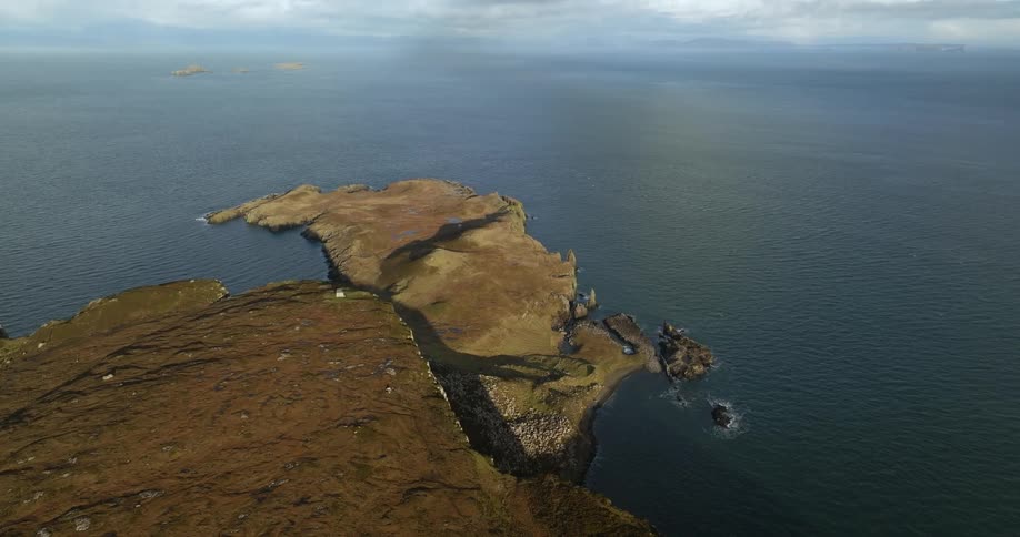 Aerial view of a narrow piece of land projecting from a coastline into the sea