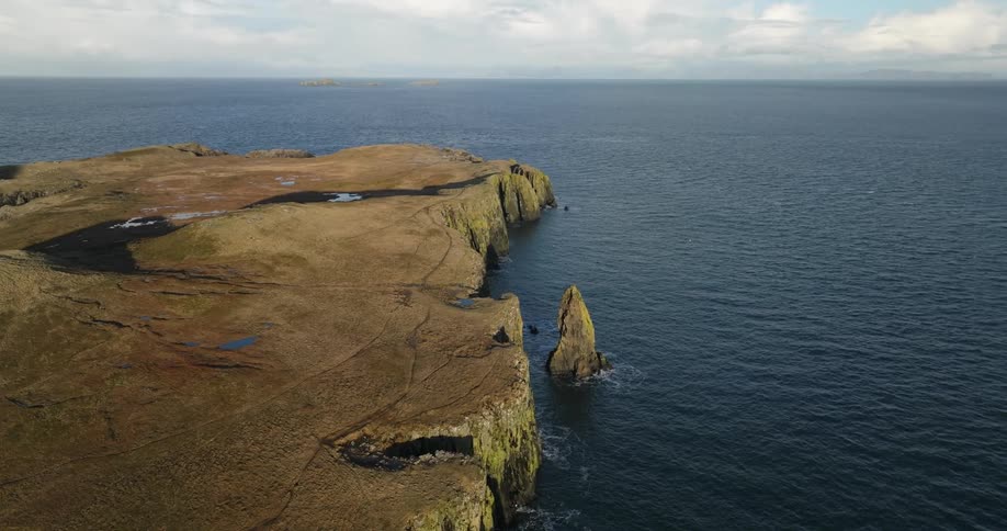 Aerial view of cliffs leading to a headland on the coast close to the ocean
