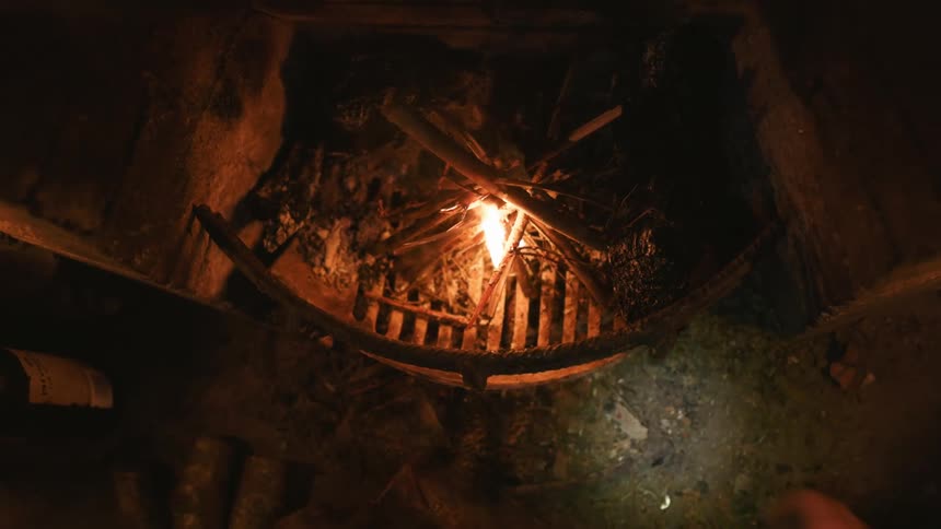 A person is lighting a fire