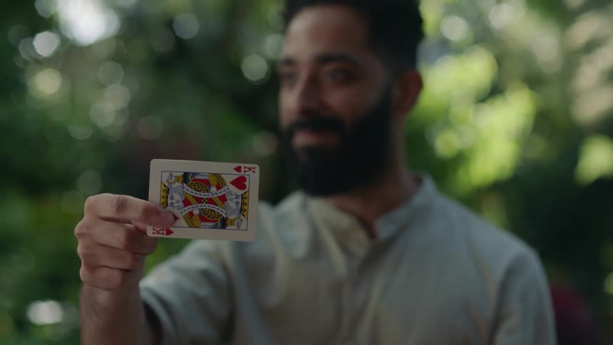 A man does a magic trick with playing cards