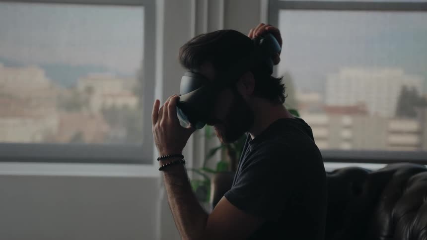 A man putting on virtual reality headset