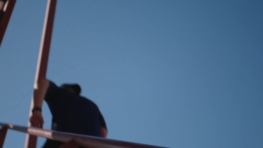 A man is jogging up a flight of stairs outdoors