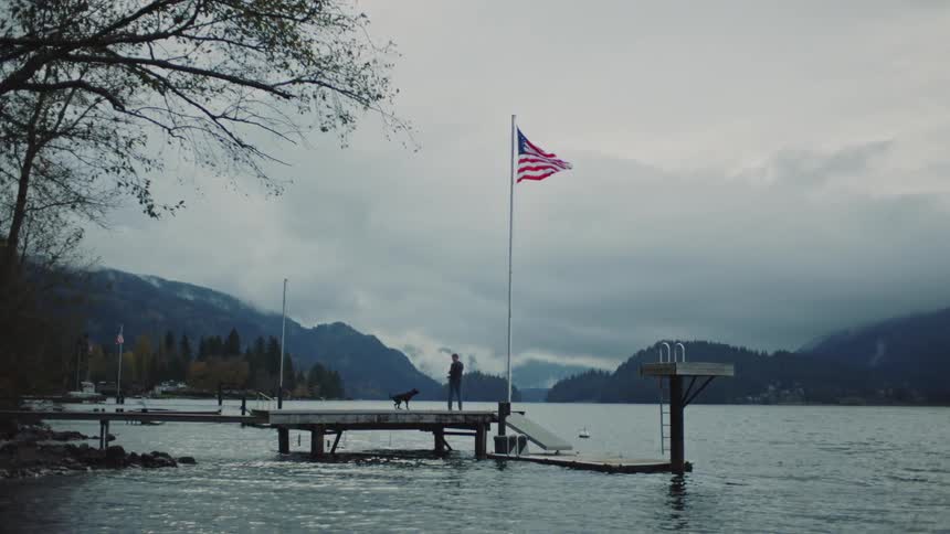 A man and dog are on the pier