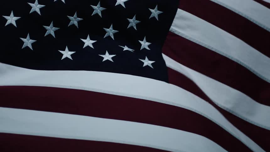 An american flag is waving in the wind