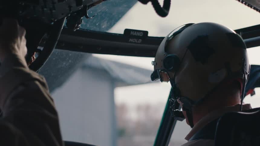 Pilots with flight helmets start helicopter