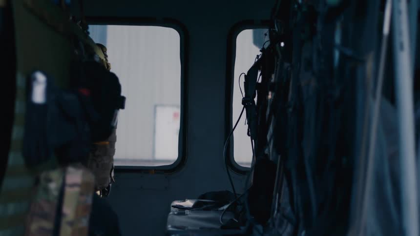 Clothing and equipment hang along the sides of the walls of a business van