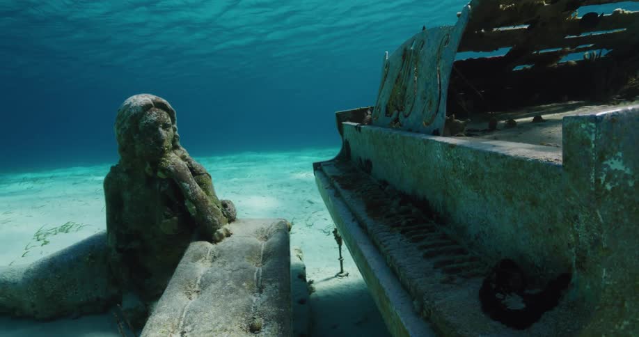 Sculpture of a mermaid and grand piano underwater
