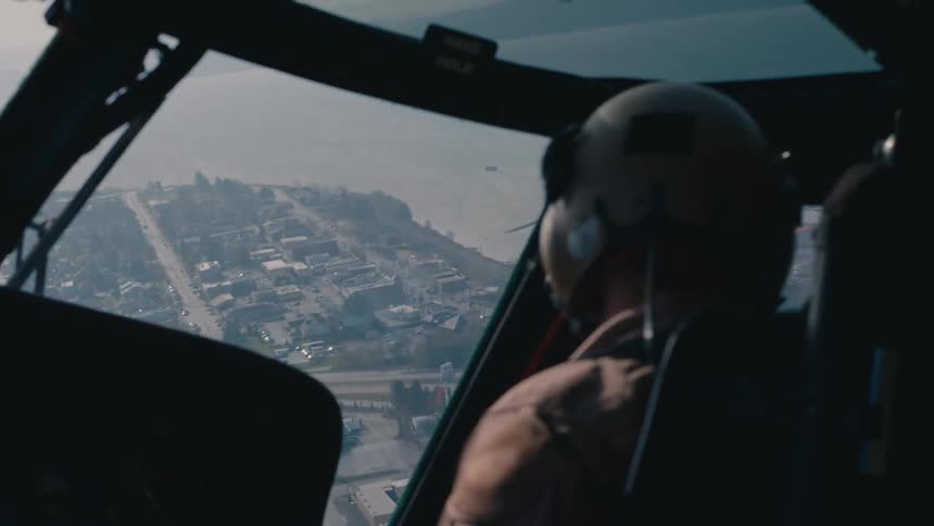 A person piloting a helicopter