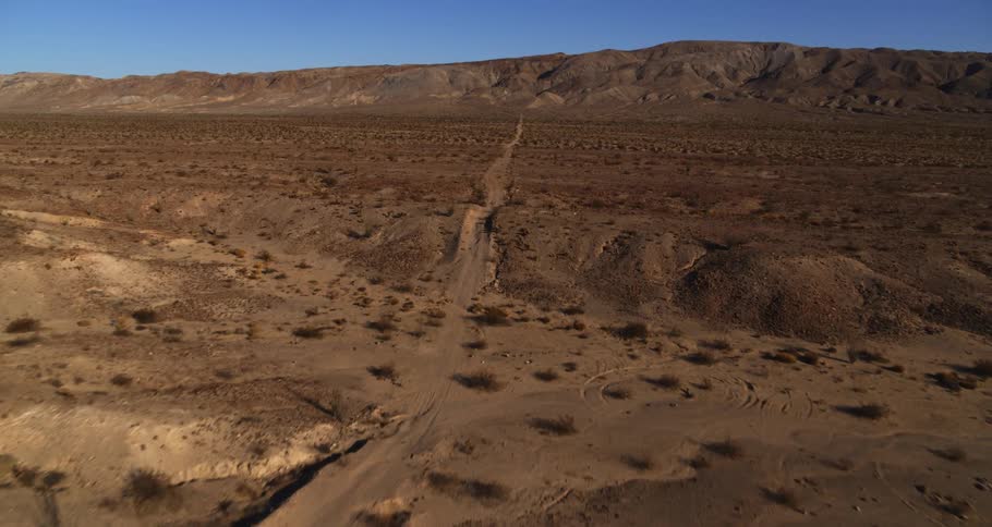 A small trail runs through the desert