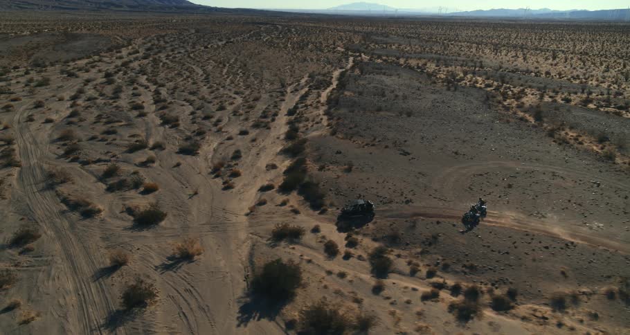 Cars are driving through the desert together