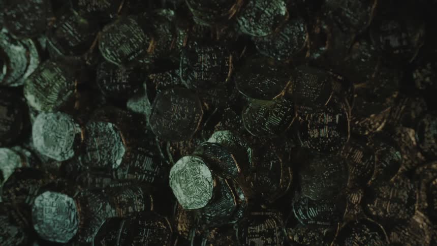Coins fall onto a pile of coins