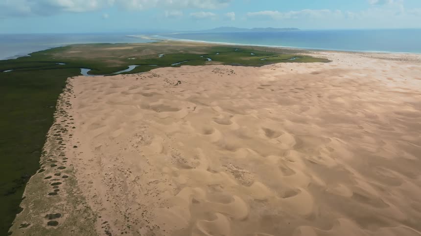 A sandy island during spring is displayed