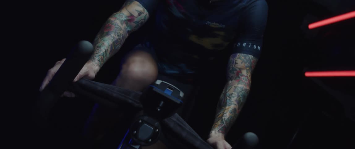 A man is riding a stationary bike