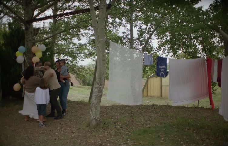 Family greet each other on the backyard for a house for a party