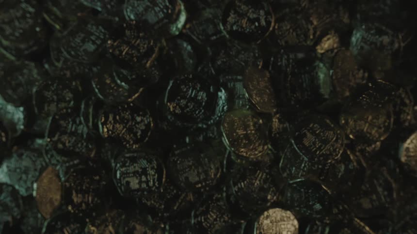 Ancient coins falling into a pile