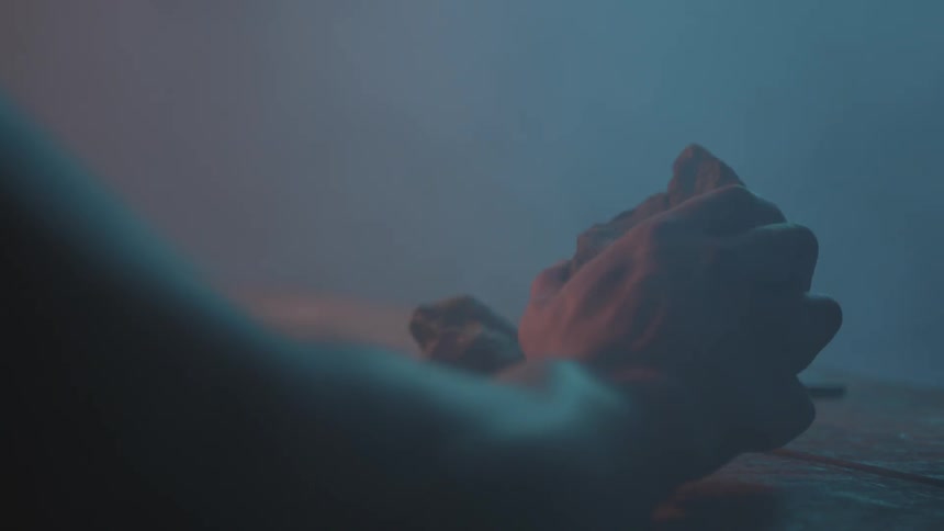 A hand picks up a rock