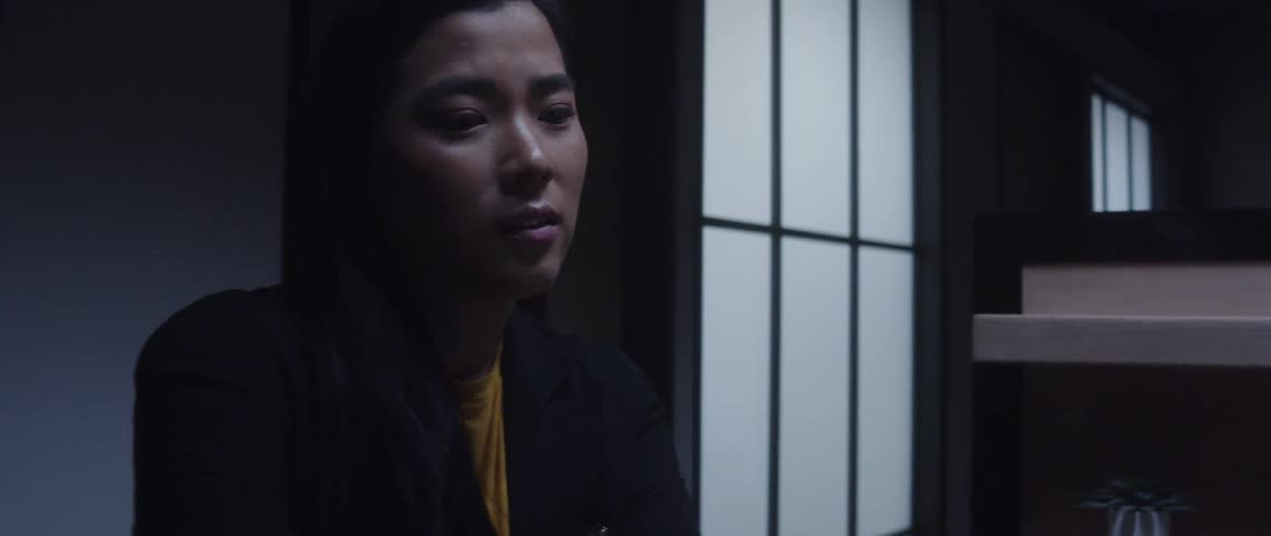 A woman is listening to someone talking in the office