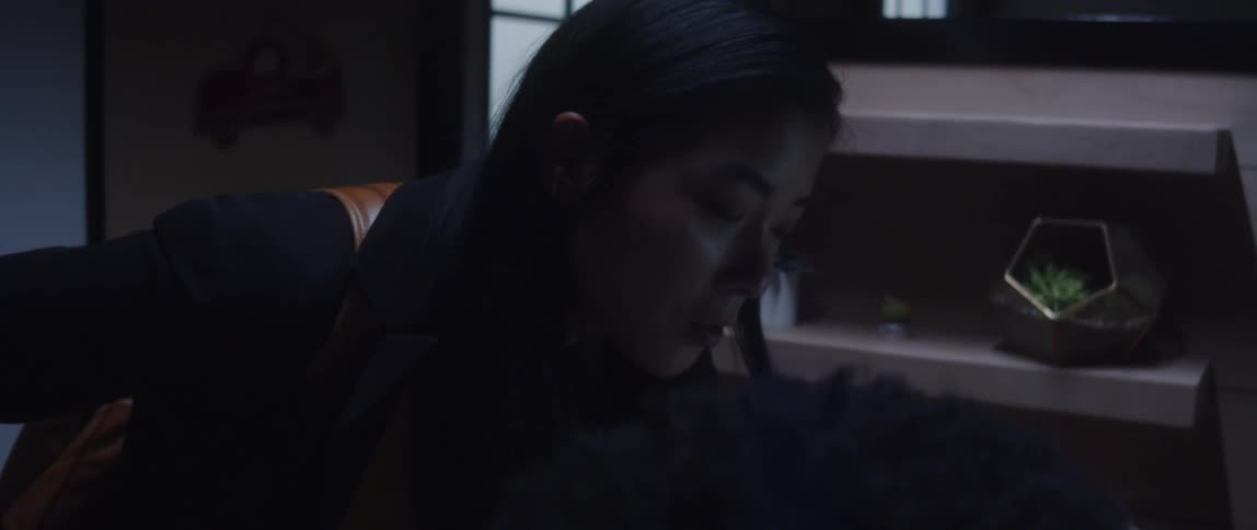 Two coworkers talking while working in office cubicle
