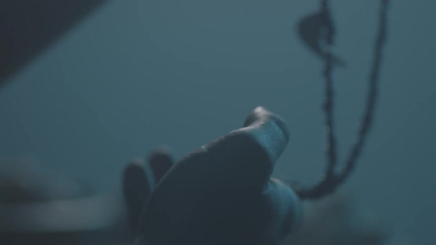 A person wraps a necklace in their hands