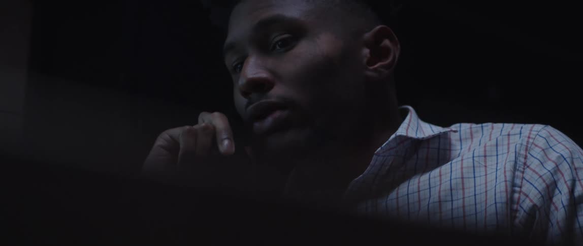 Man gestures while talking on the phone