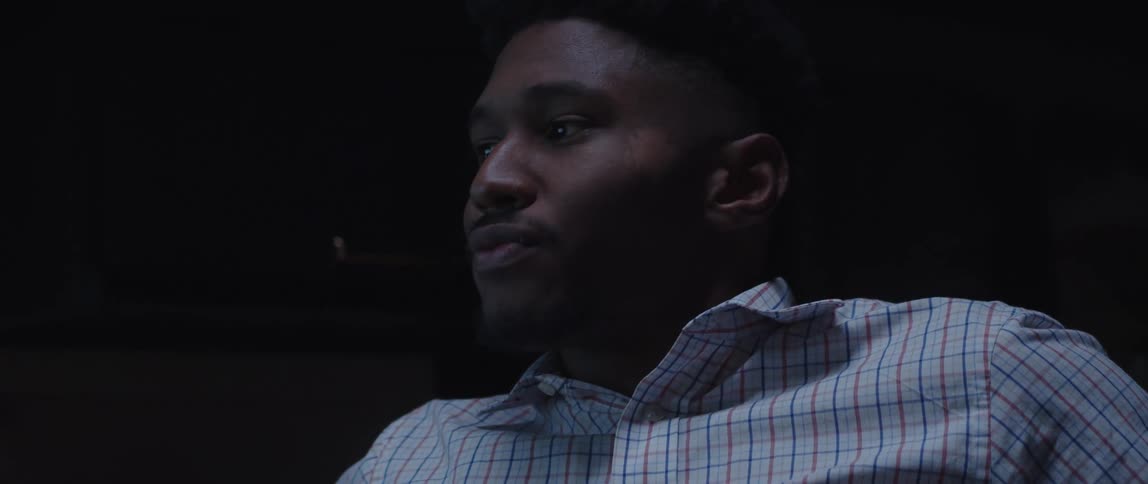 A man working late in office contemplating about something