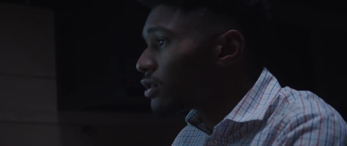 An up close of a mans face looking contemplatively and then adjust to look at something else