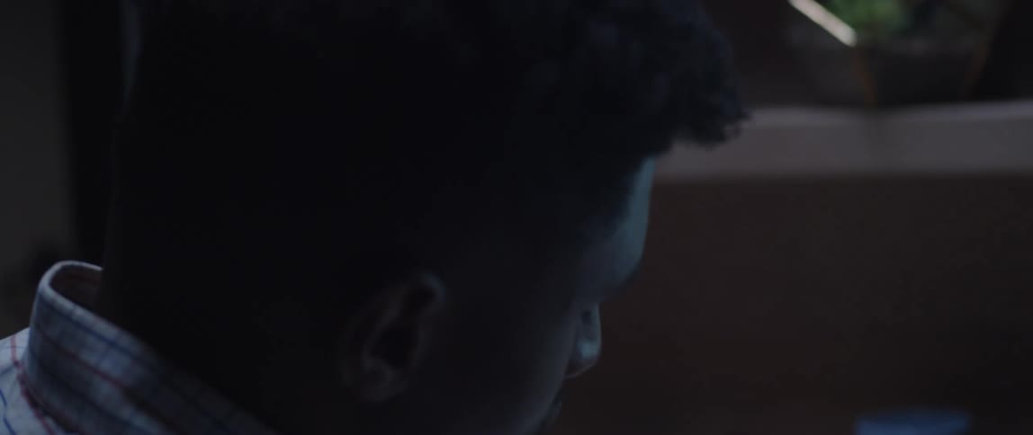 A man is looking through a folder at his desk