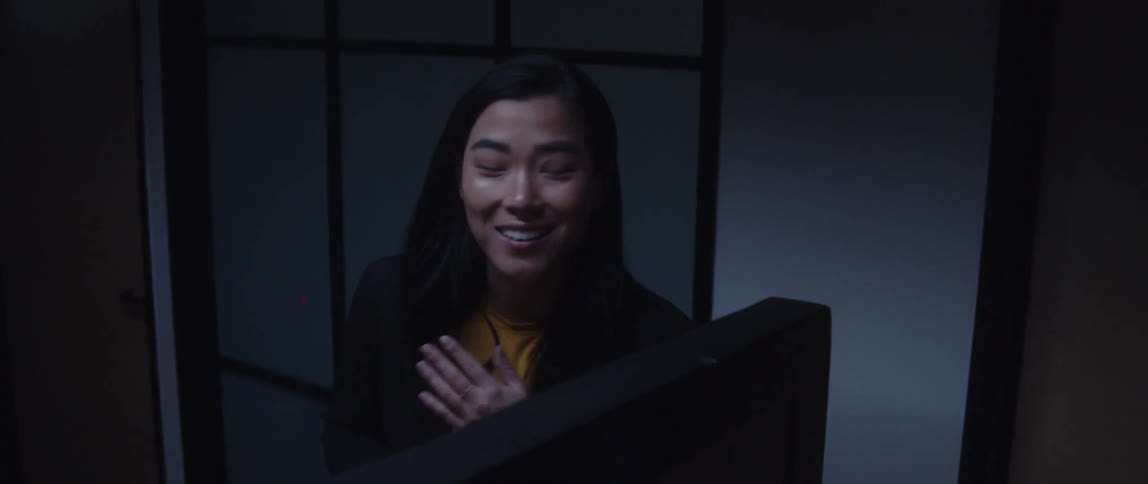 Businesswoman with blazer jacket and yellow top talks to person and gets off work