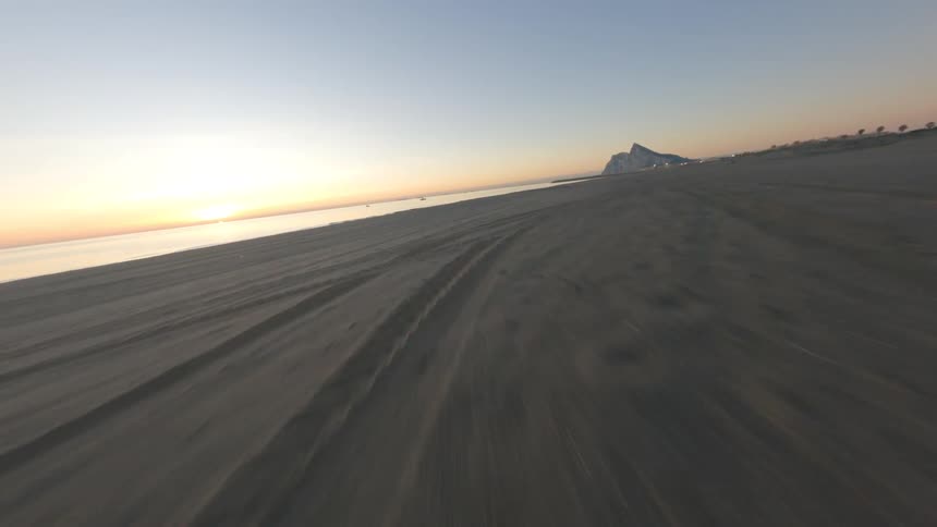 Aerial view of the coast is displayed at dusk