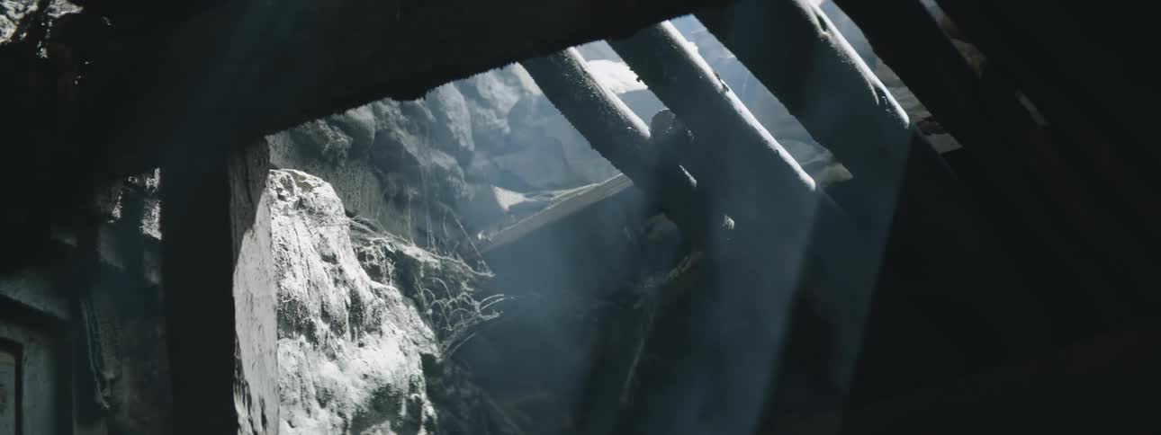Smoke rising through a hole in a wood and stone structure